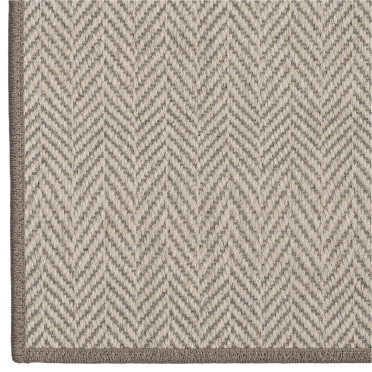 Close-up of a rug with a zigzag pattern on a neutral background