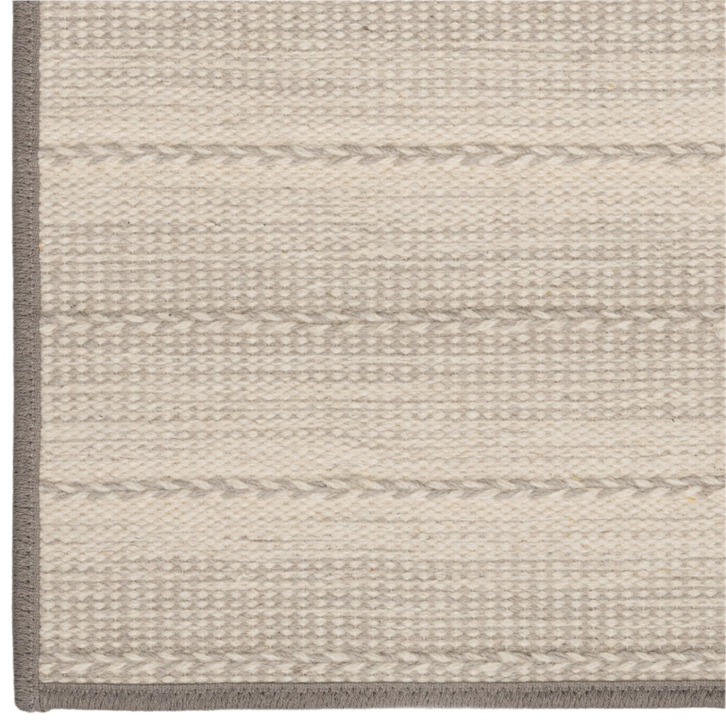 Close-up of a textured rug with horizontal stripes on a neutral background