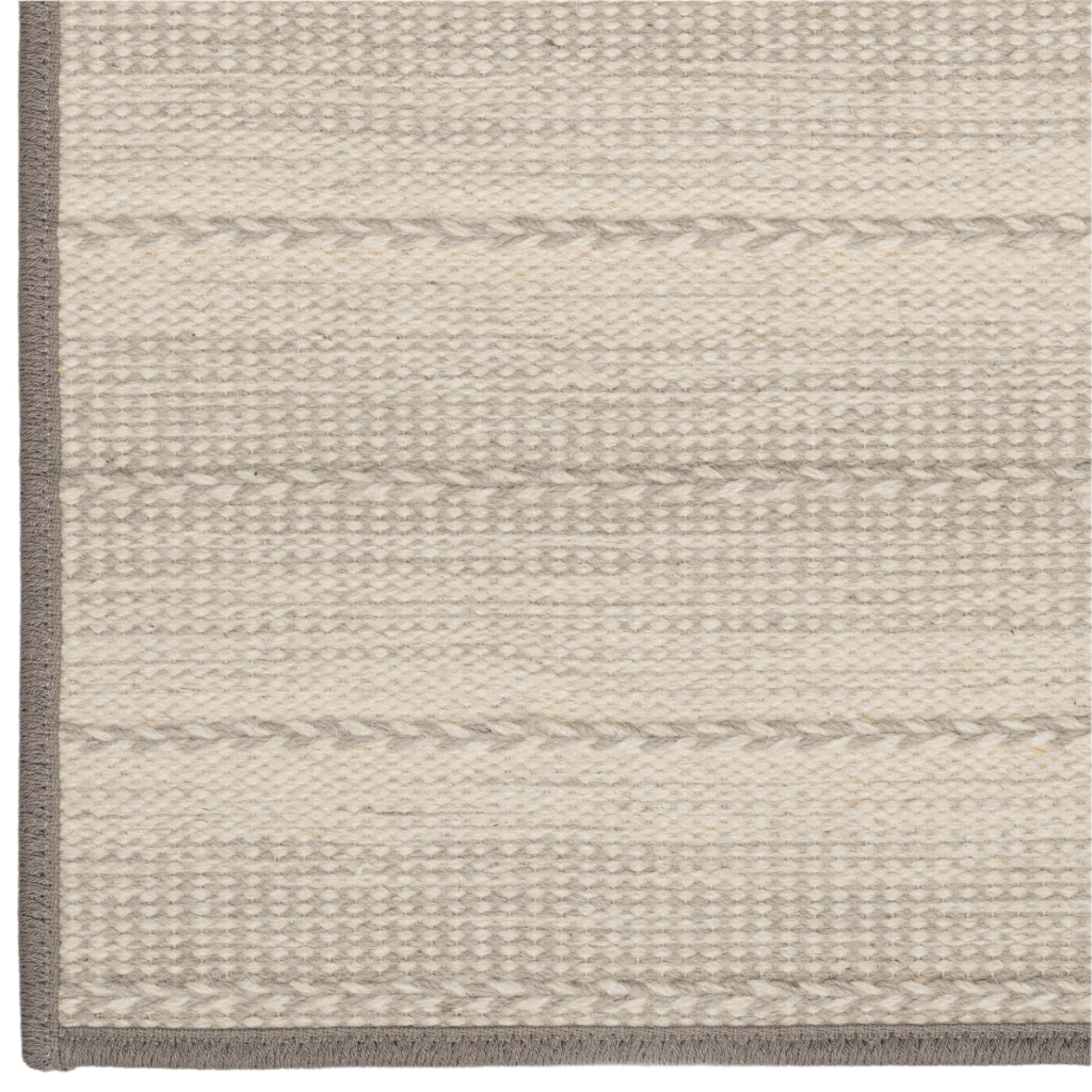Close-up of a textured rug with horizontal stripes on a neutral background