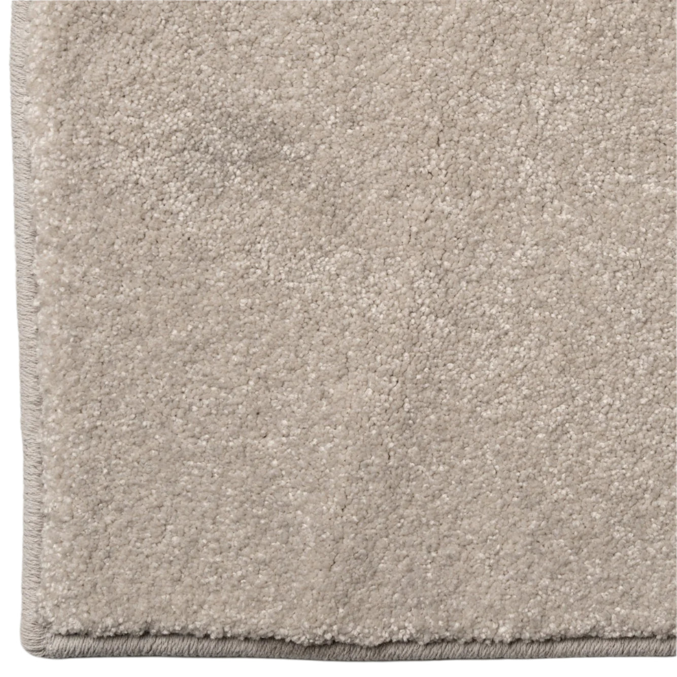 Close-up of a beige carpet with a soft texture on a white background