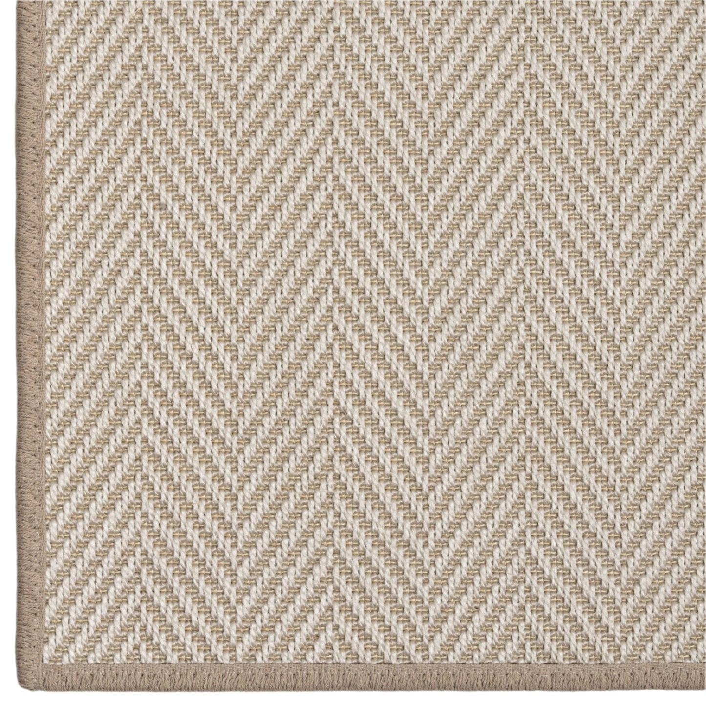 Close-up of a beige and white herringbone patterned rug.