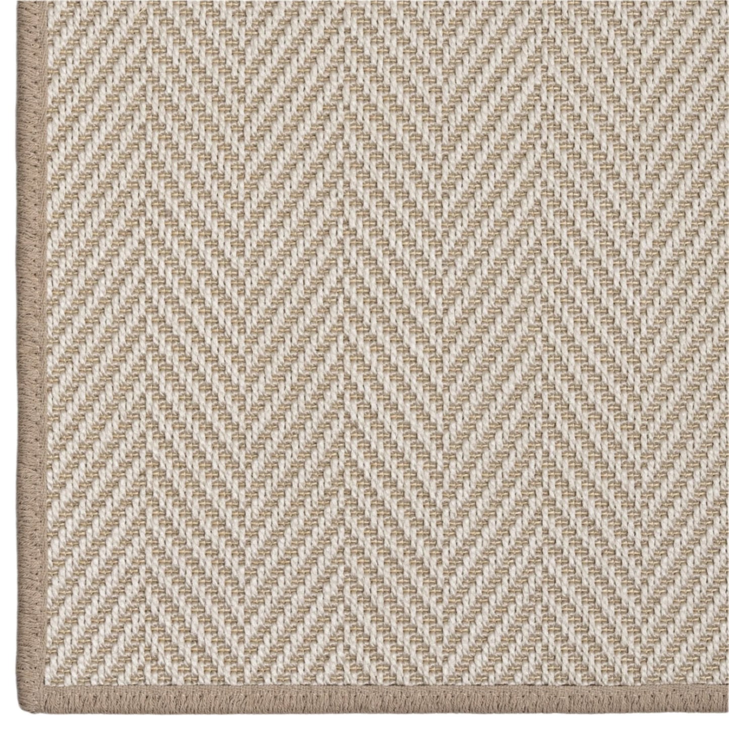 Close-up of a beige and white herringbone patterned rug.