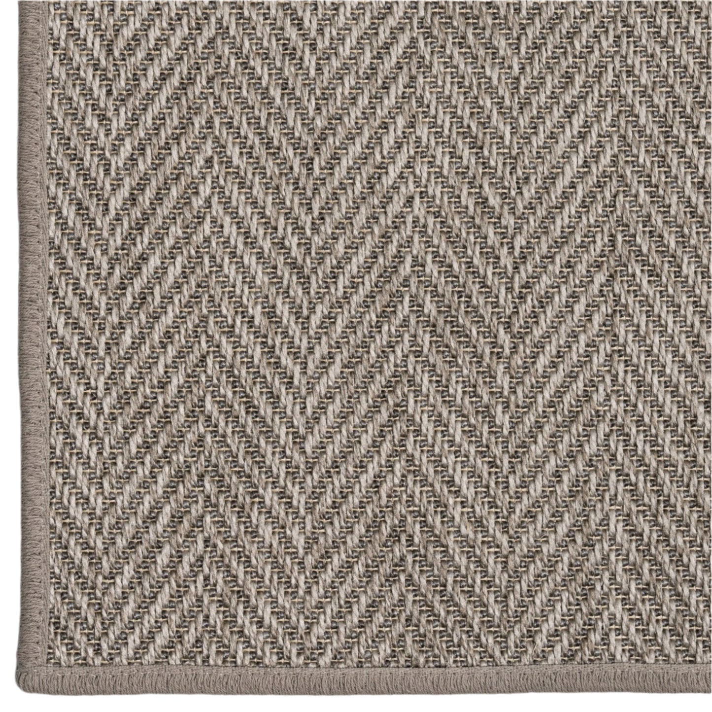Close-up of a textured fabric with a herringbone pattern in neutral colors.