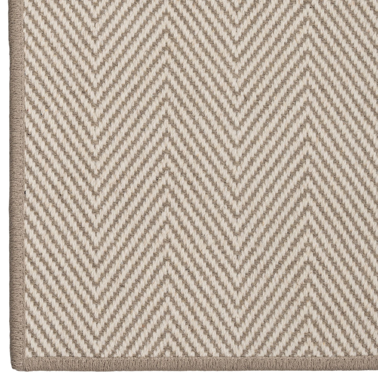 Close-up of a beige and white zigzag patterned rug.