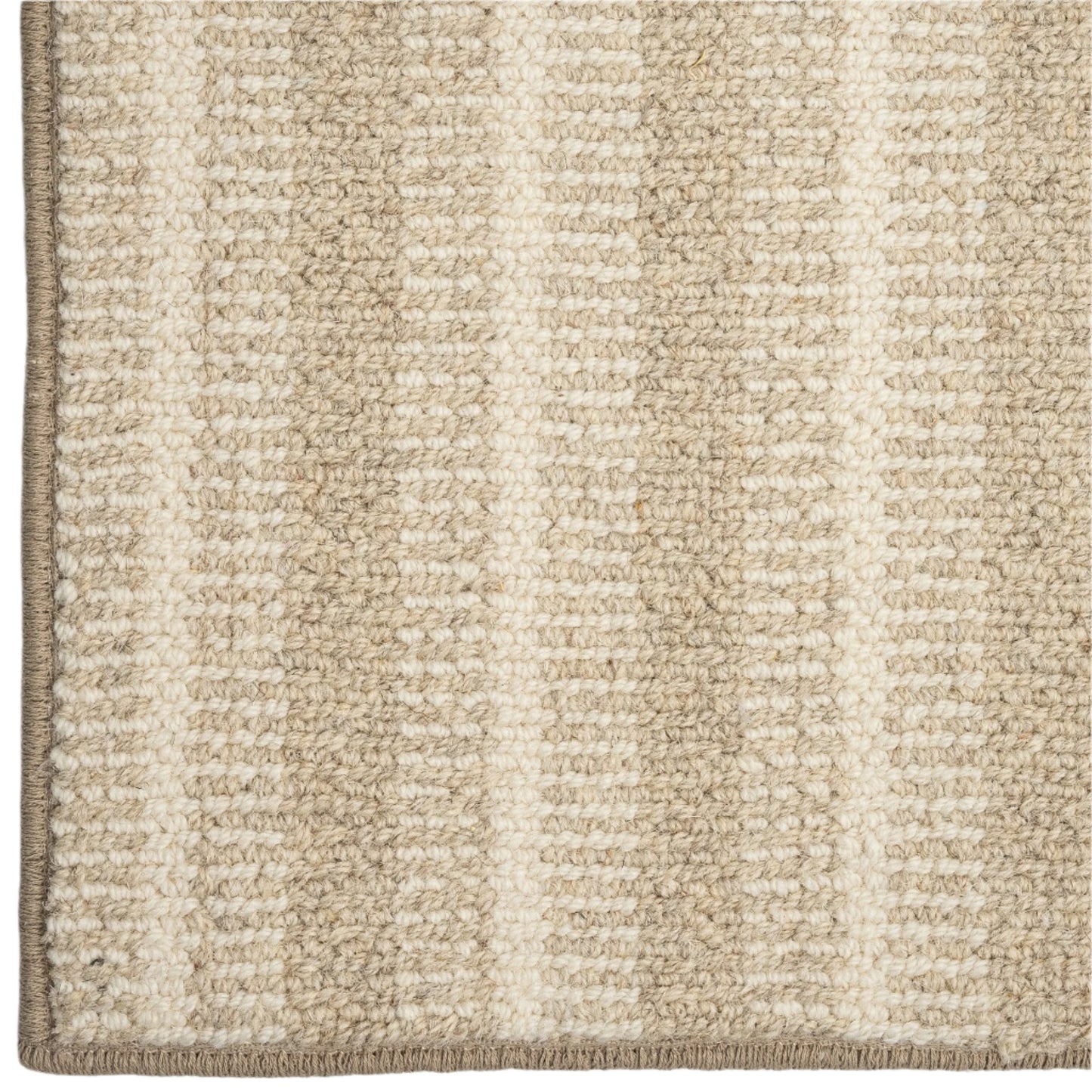 Close-up of a textured beige and white striped rug corner.