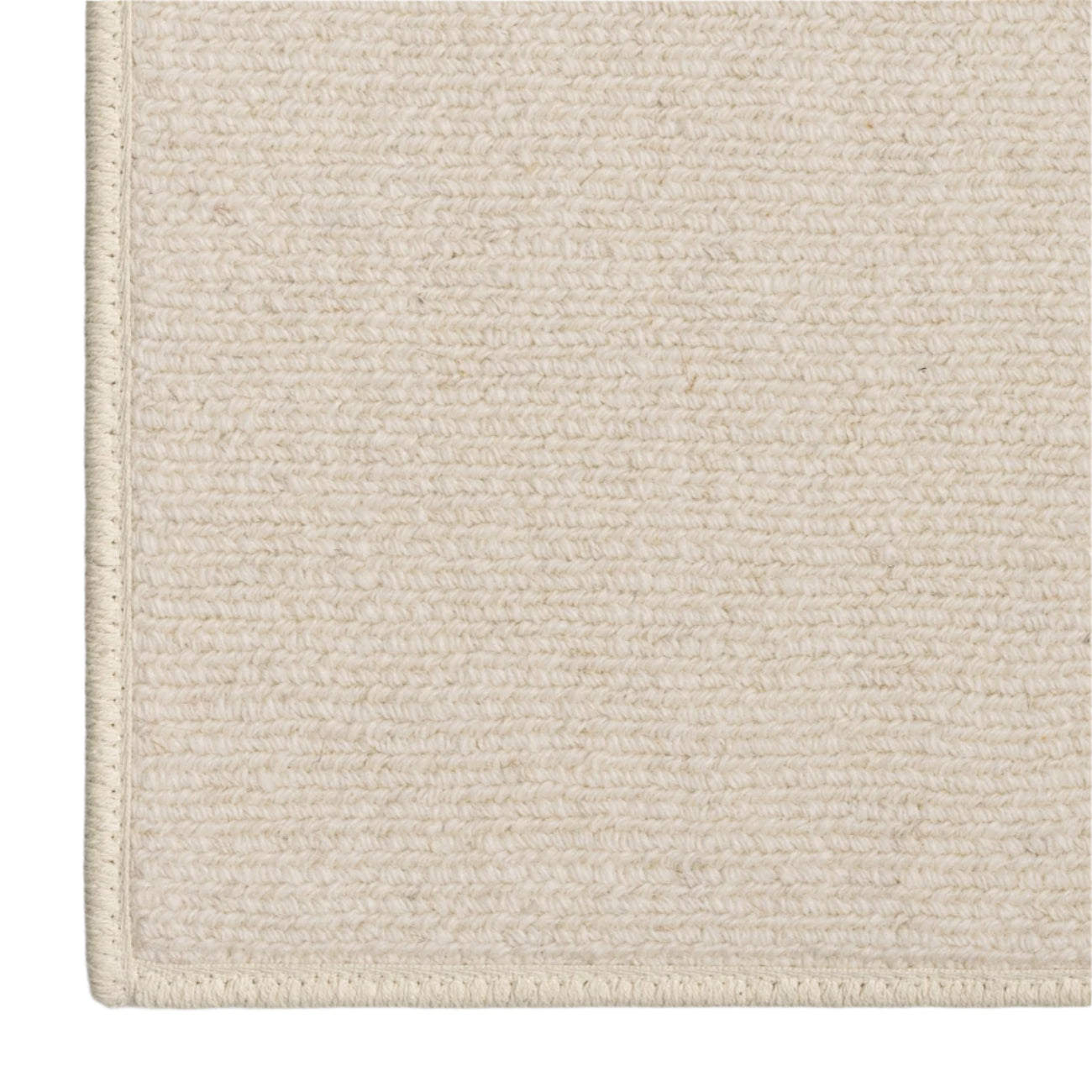 Close-up of a textured beige rug corner