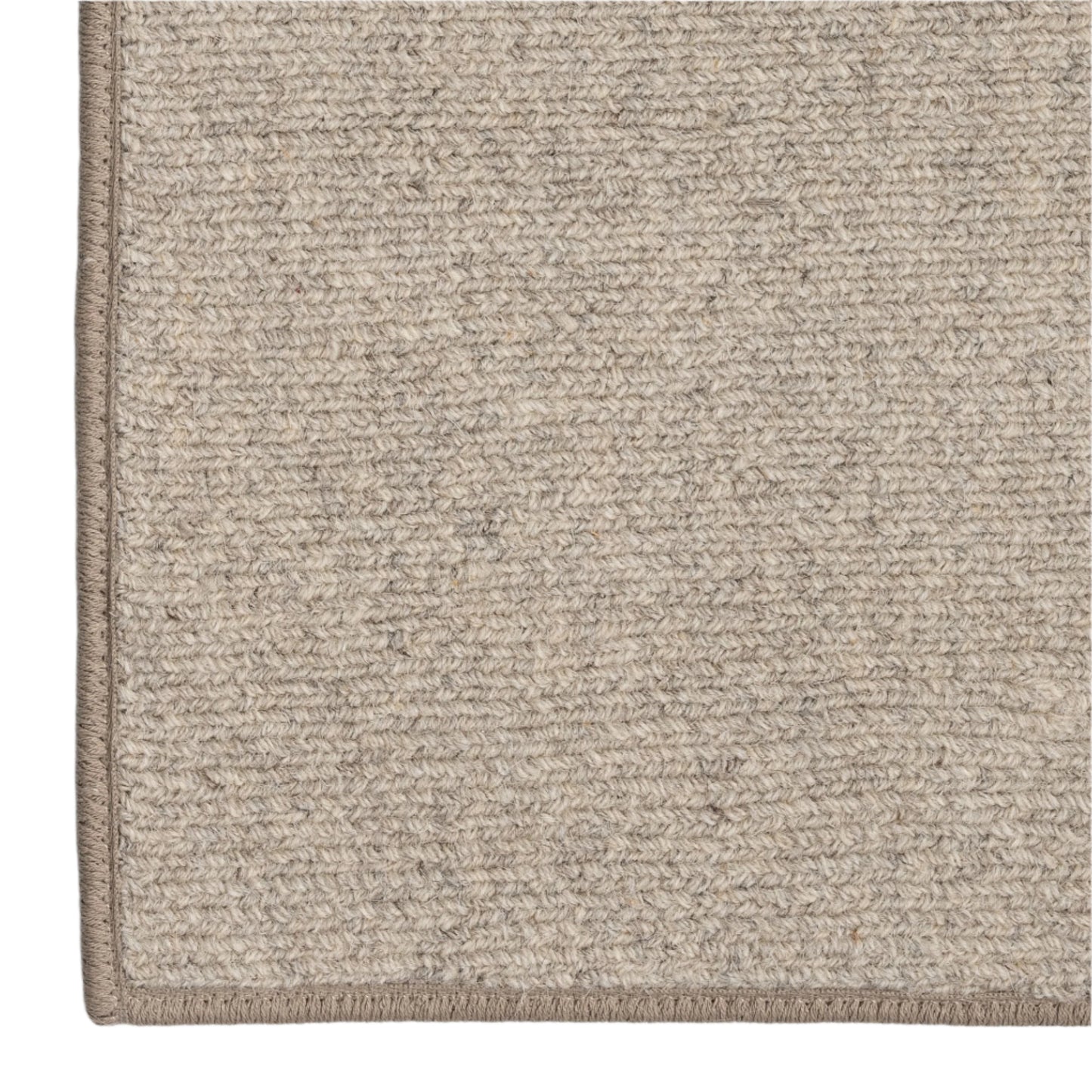 Close-up of a textured beige rug corner on a white background