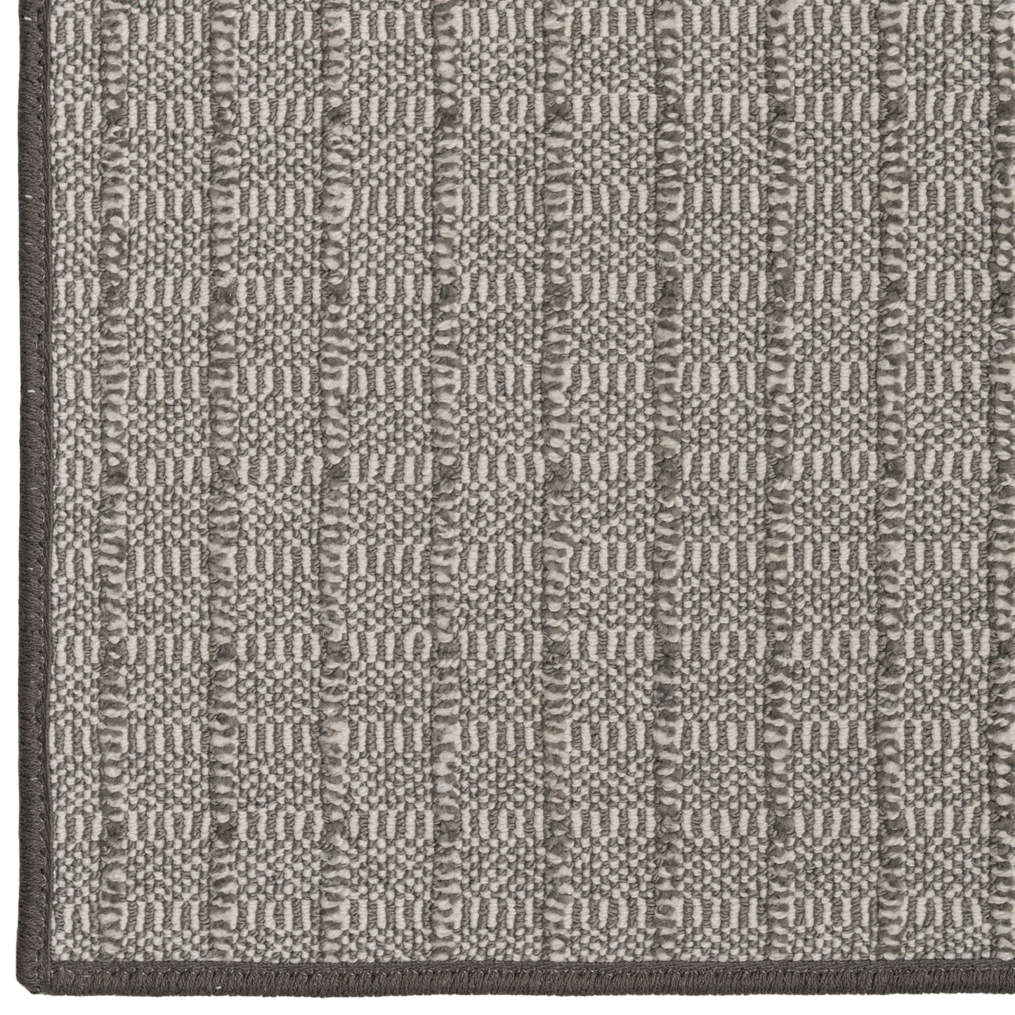 Close-up of a textured gray and white rug with geometric pattern