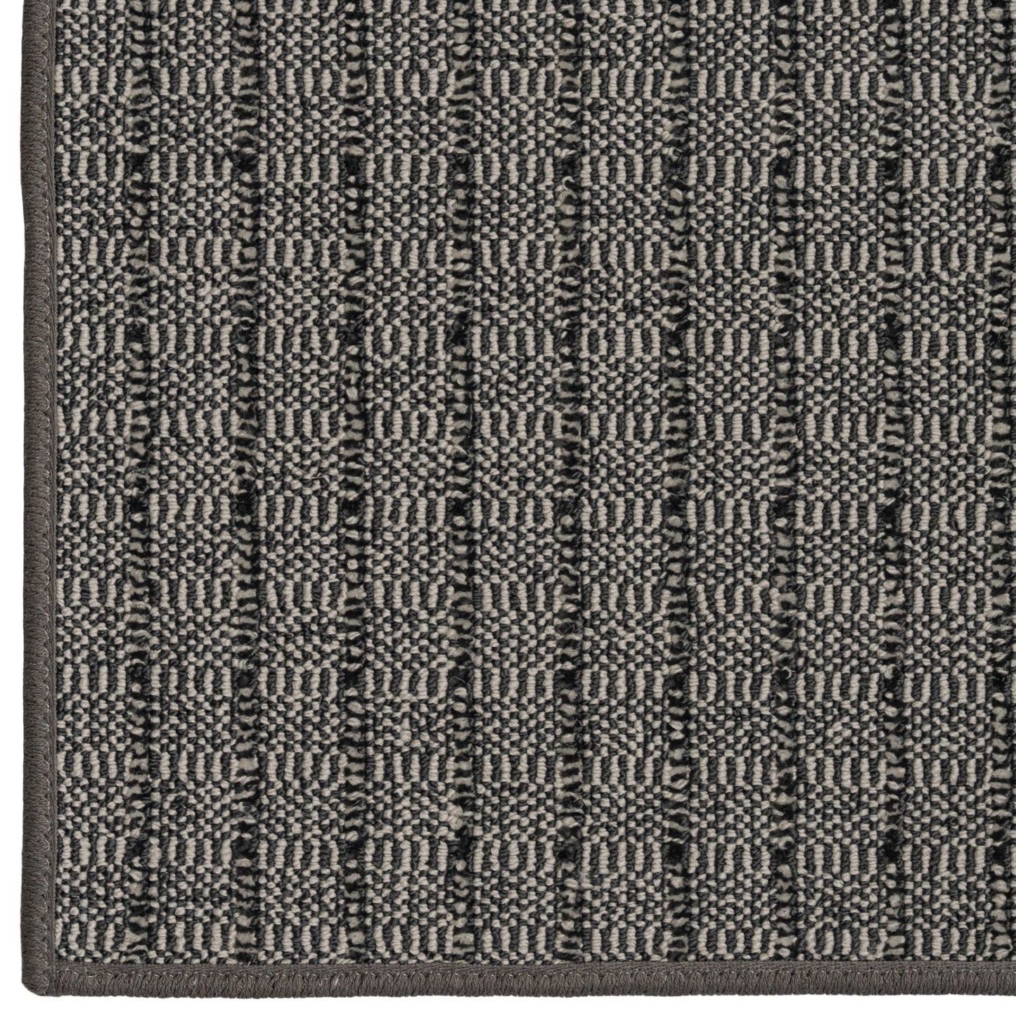Close-up of a textured gray rug with a geometric pattern