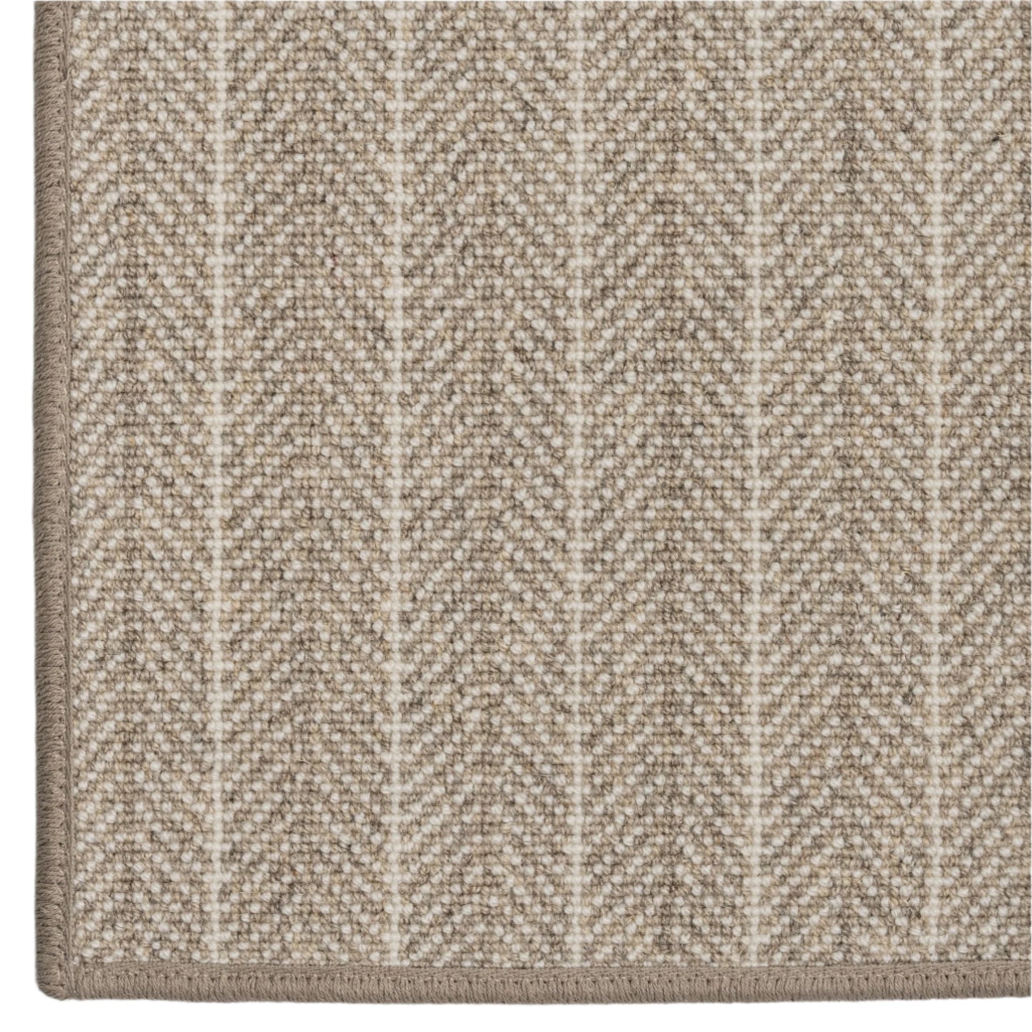 Close-up of a textured beige carpet with a subtle chevron pattern on a white background