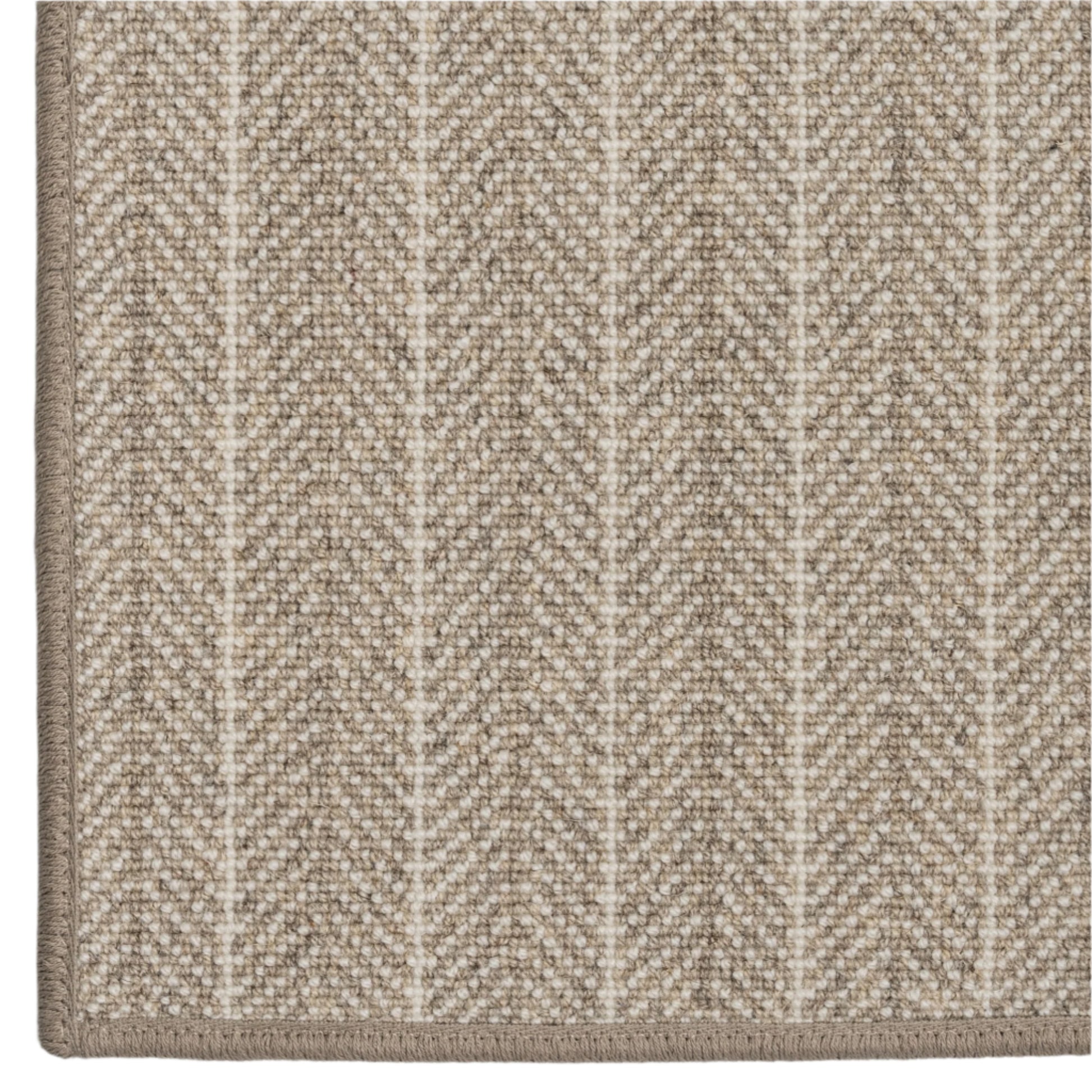 Close-up of a textured beige carpet with a subtle chevron pattern on a white background
