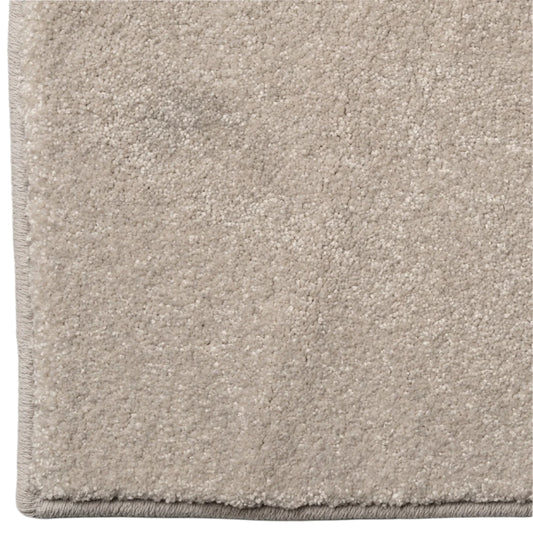 Close-up of a beige carpet with a soft texture on a white background