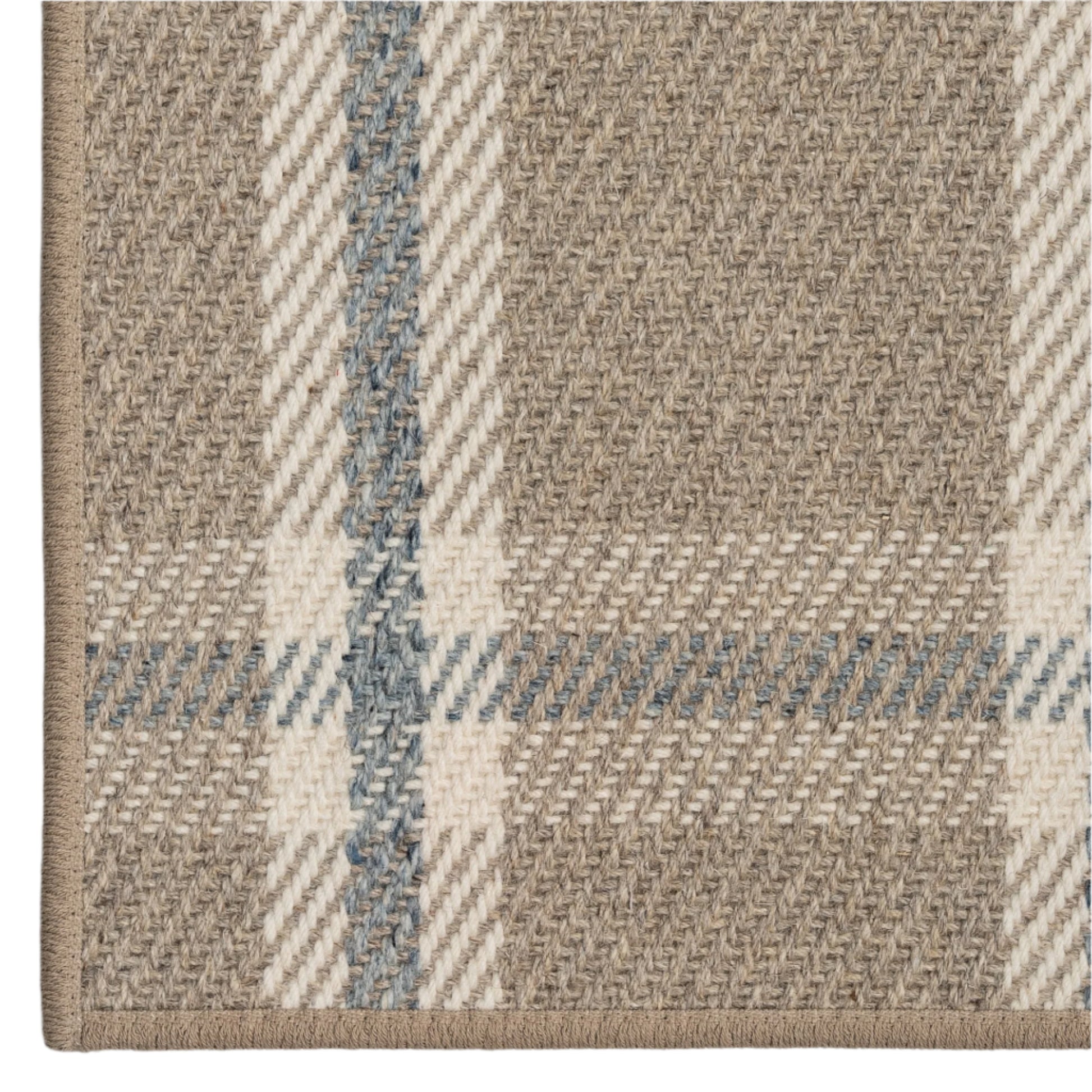 Close-up of a textured fabric with plaid pattern in beige and blue.