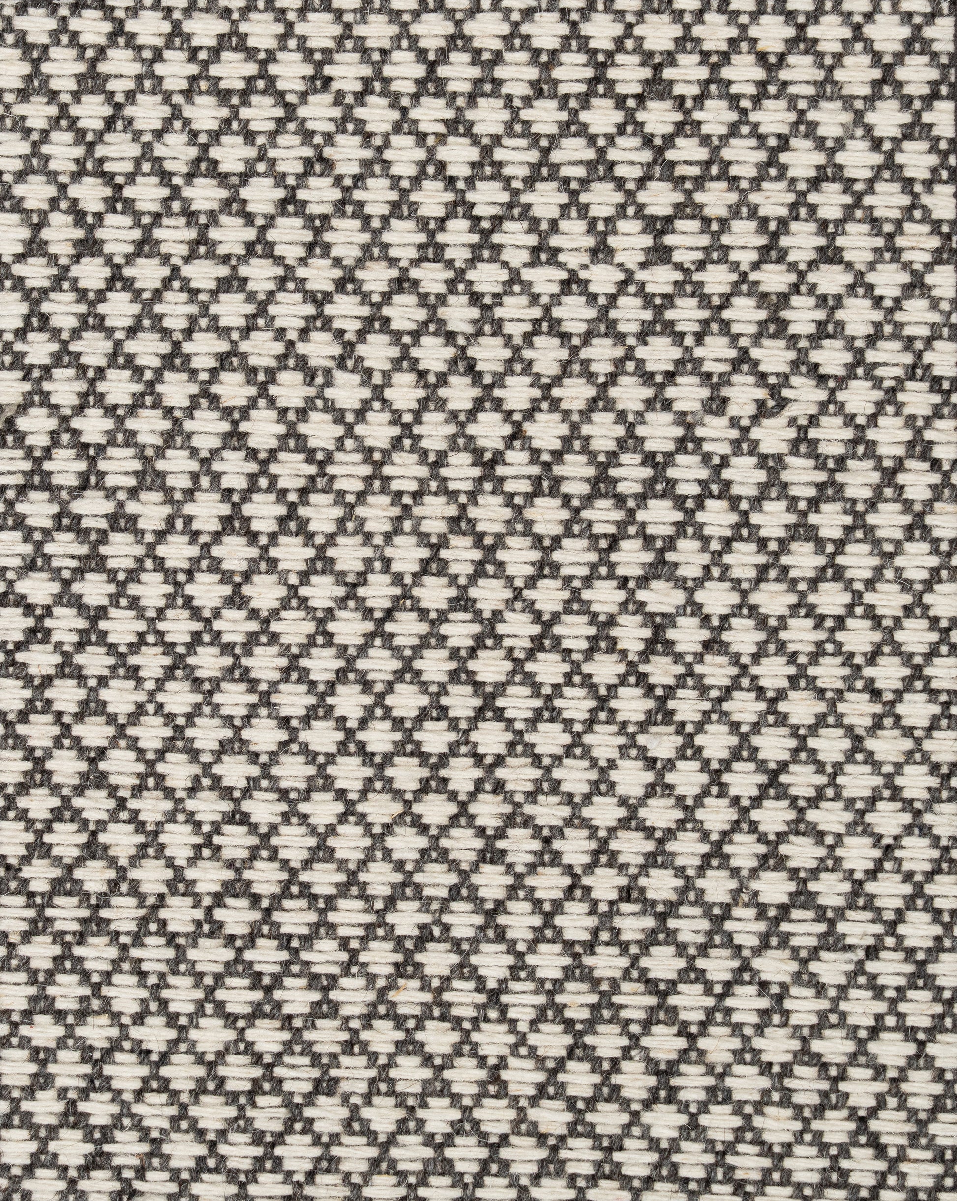 A hand-loomed black nd white geometric wool carpet with a small-scale diamond pattern that looks gorgeous as living room carpet, bedroom carpet, or on stair. 