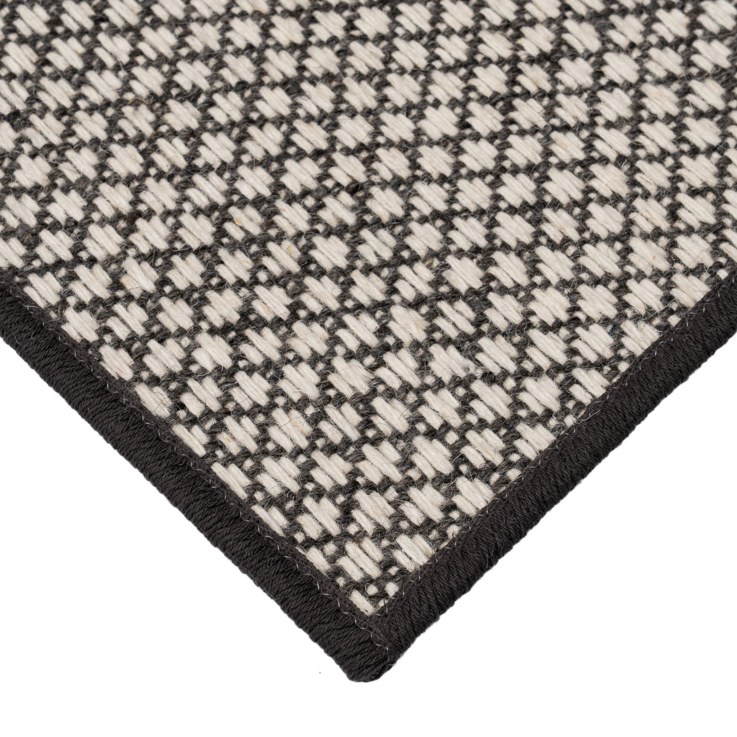 Pixie Carbon black and white rug corner. 