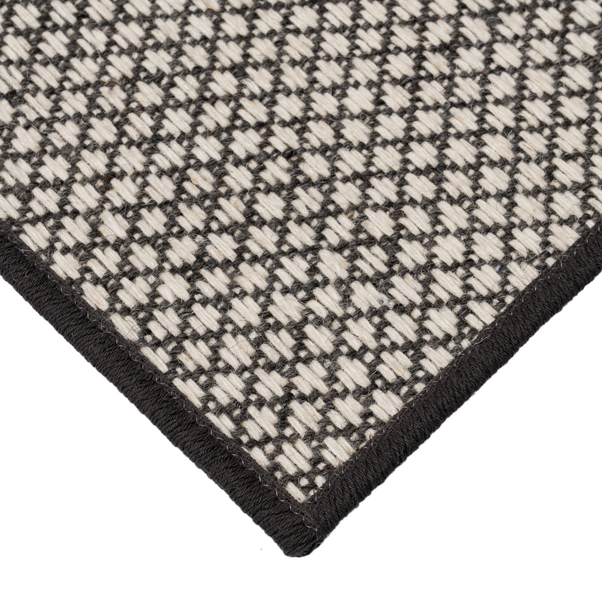 Pixie Carbon black and white rug corner. 