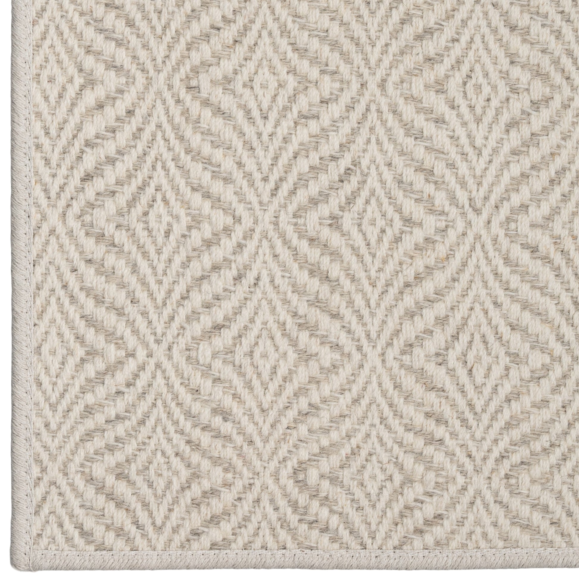 Textured beige carpet with a geometric pattern