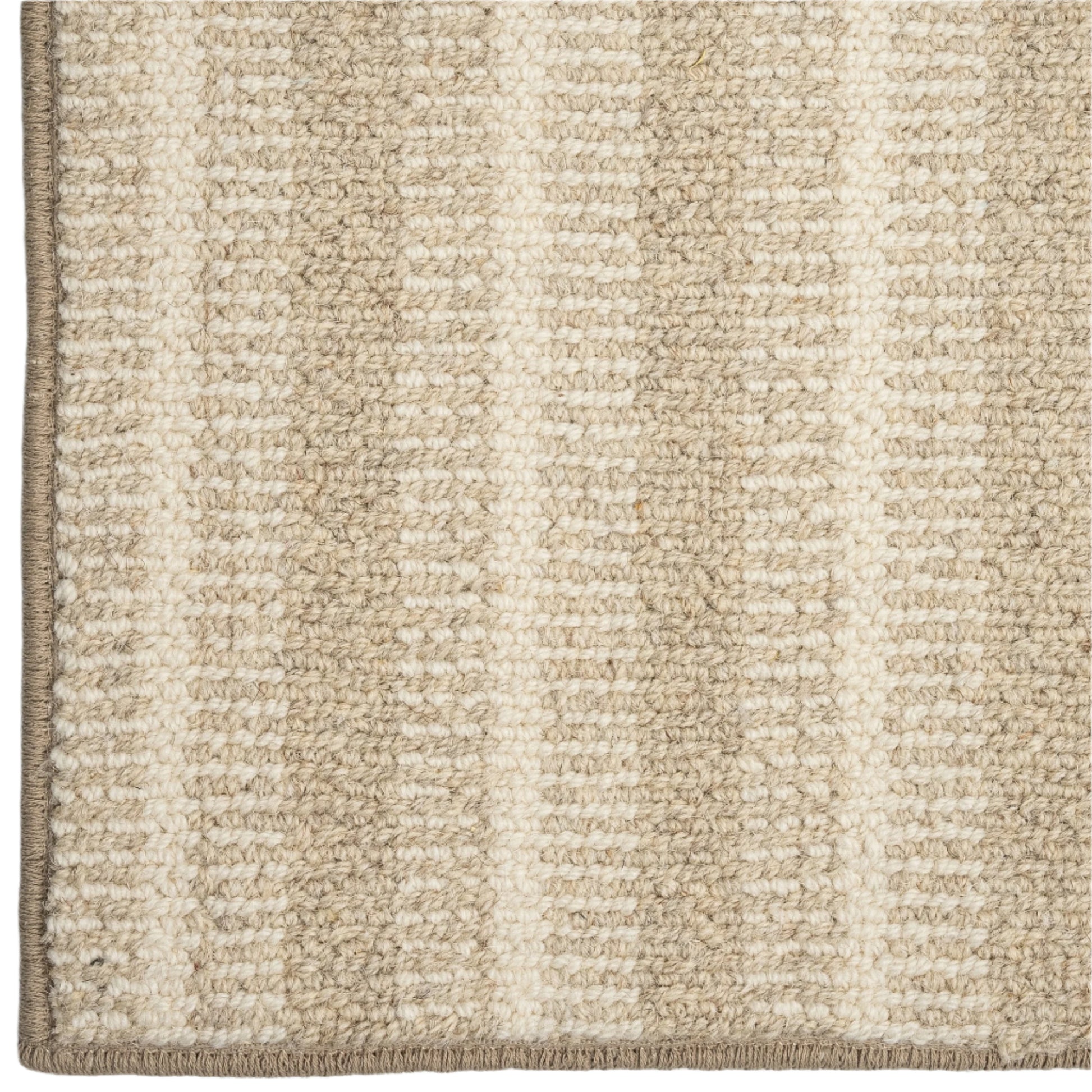 Close-up of a textured beige and white striped rug corner.