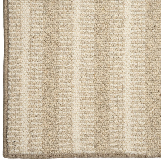 Close-up of a textured beige and white striped rug corner.