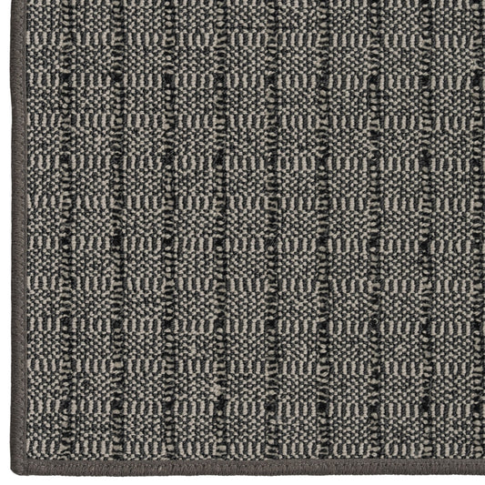 Close-up of a textured gray rug with a geometric pattern
