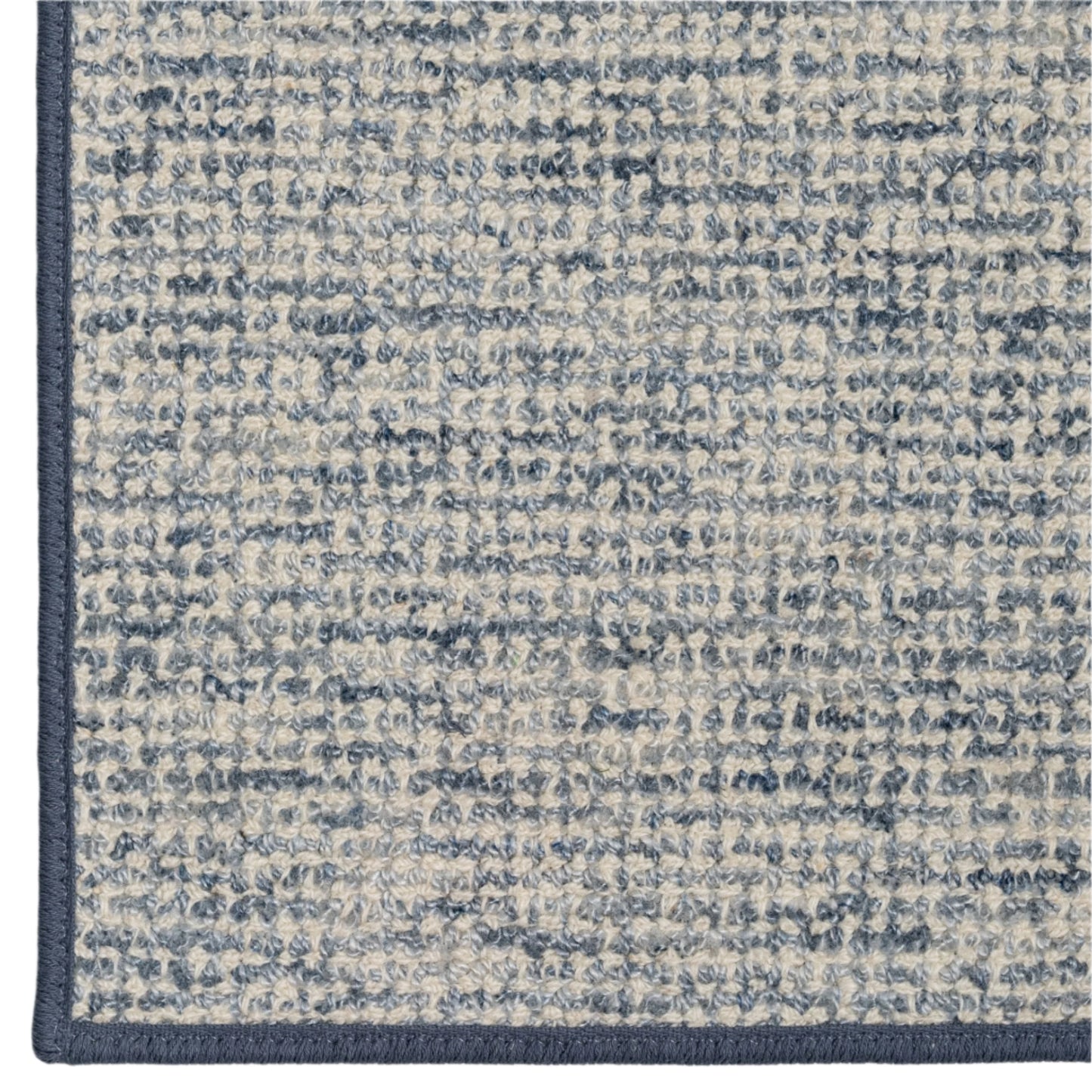 Close-up of a textured blue and gray rug corner