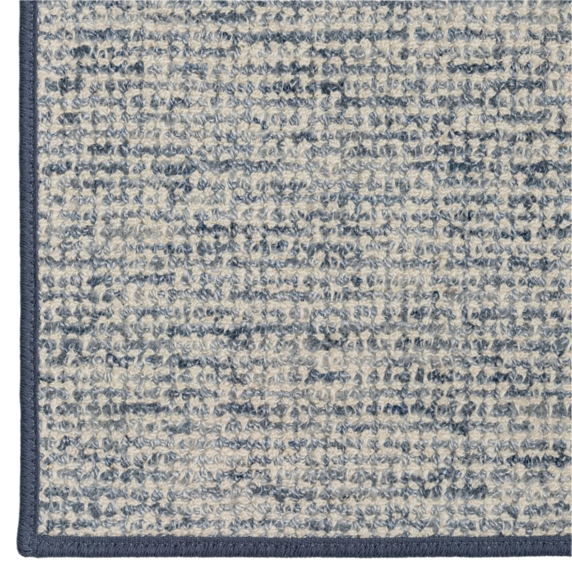 Close-up of a textured blue and gray rug corner