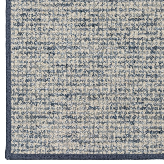 Close-up of a textured blue and gray rug corner