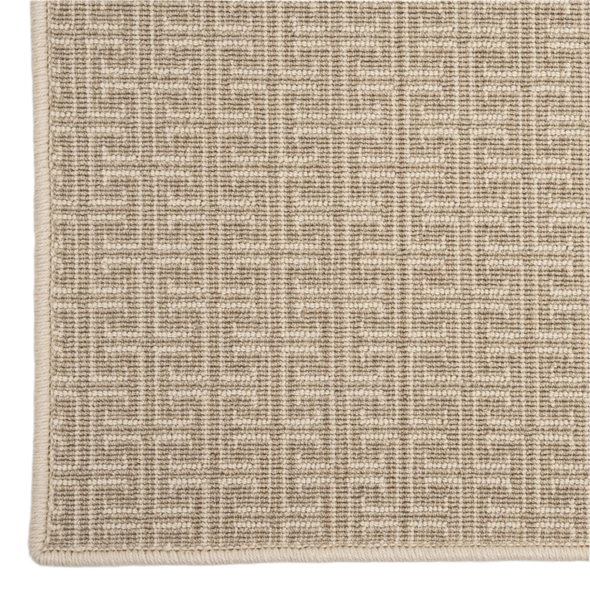 Textured beige rug with a subtle pattern on a light gray background